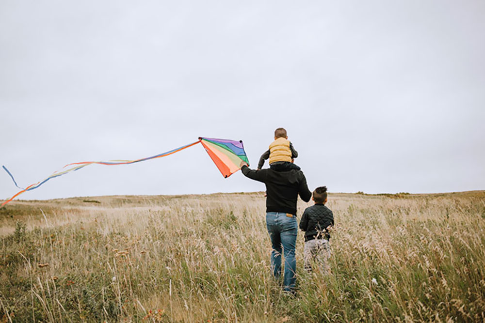 A father plays with a kite in the Northwest Calgary community of Ambleton